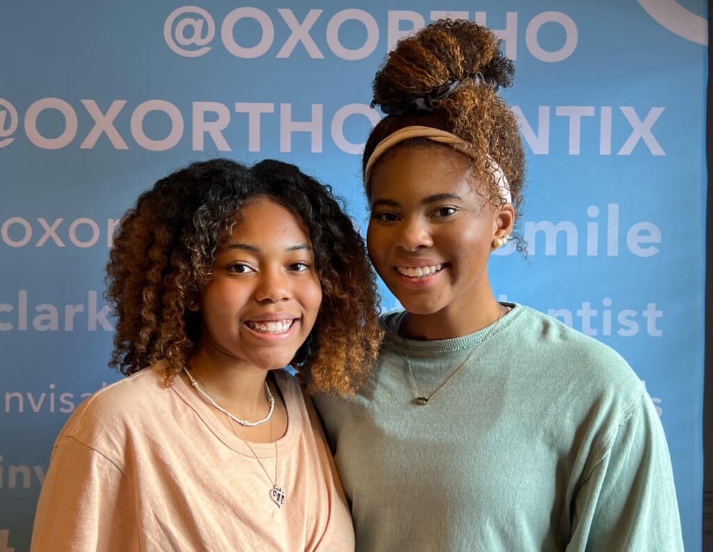 two teens smiling after appointment at OX Orthodontix
