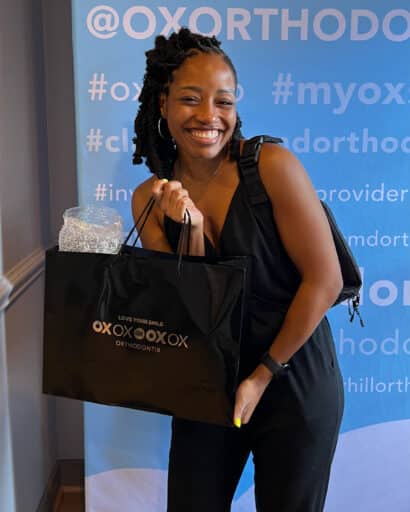 patient with gift bag at Clarksville office after appointment at OX Orthodontix