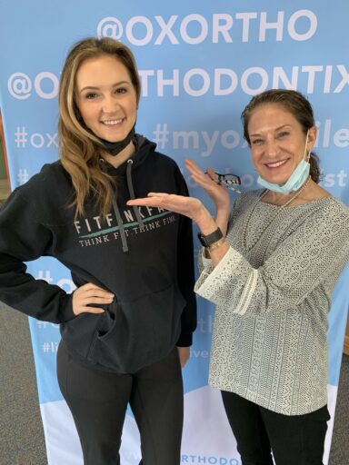 Dr. Selnick posing with patient at OX Orthodontix office